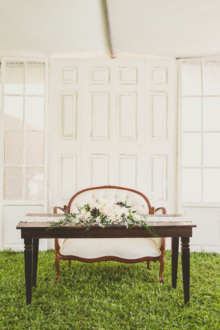 “We found amazing antique furniture through Craigslist,” Roxy says. “Each piece was picked with love and affection.” They chose a neutral and ivory couch with intricate detailing along the wood trim and a tufted back. The antique accents gave the entire night character and a direct representation of them.