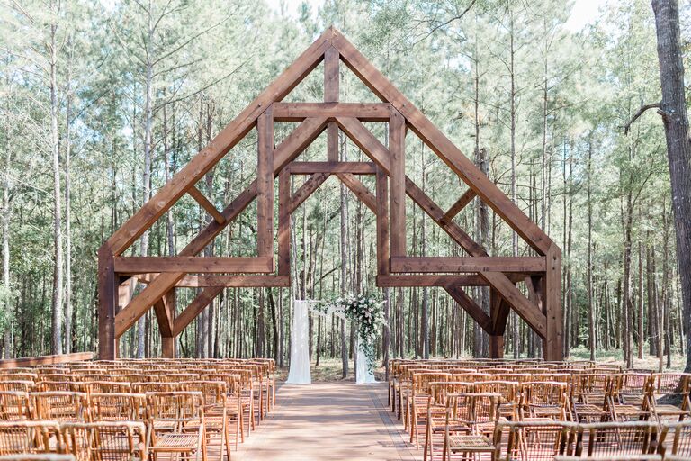 Outdoor wedding ceremony space with wood chapel-like structure