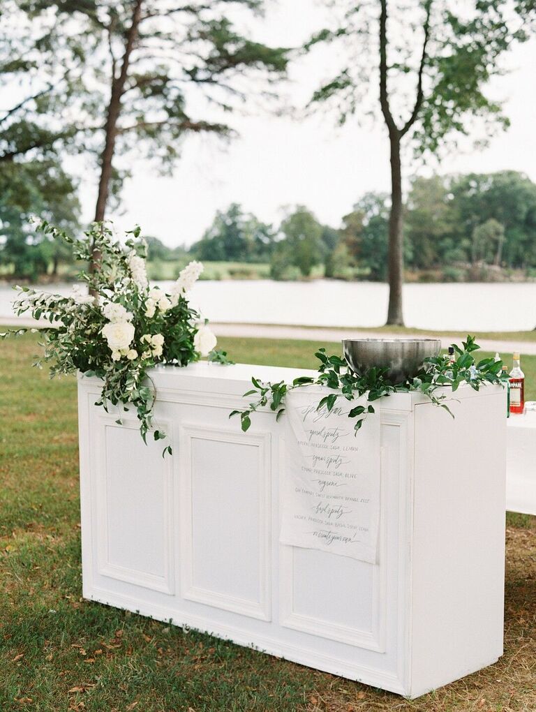 White bar front covered with greenery