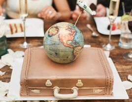 Traveling couple's groom's cake with globe, suitcase and airplace