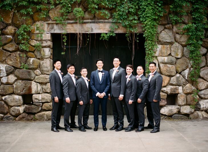 To ensure that his midnight blue tuxedo stood out, Stephen had his groomsmen don classic gray suits, which they teamed with blush bow ties and smart black dress shoes for a polished finish.