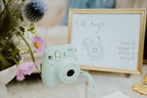Instax Polaroid Camera on Coffee Table With Sign for Guests to Use During Intimate Wedding