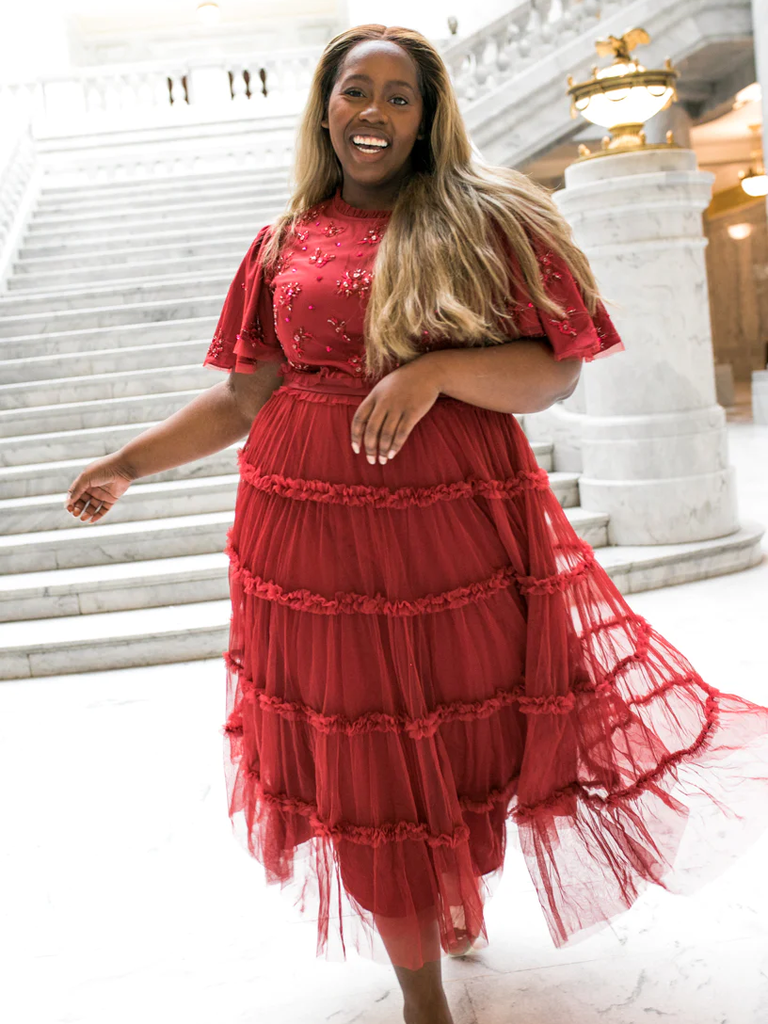 A model shows off this lovely floral wedding guest dress.