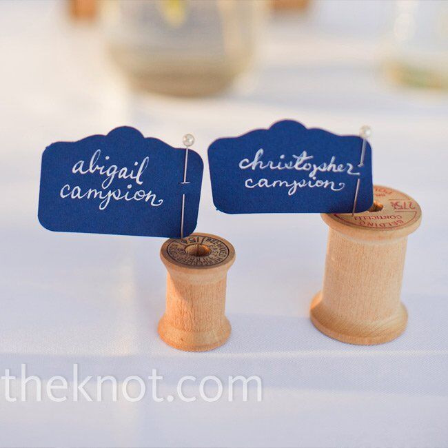 Abigail had her sister calligraph each guest’s name onto a navy flag, which she pinned onto spools for the escort cards.
