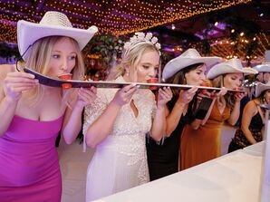 Bride and Wedding Guests Doing Shotski Shots at Reception