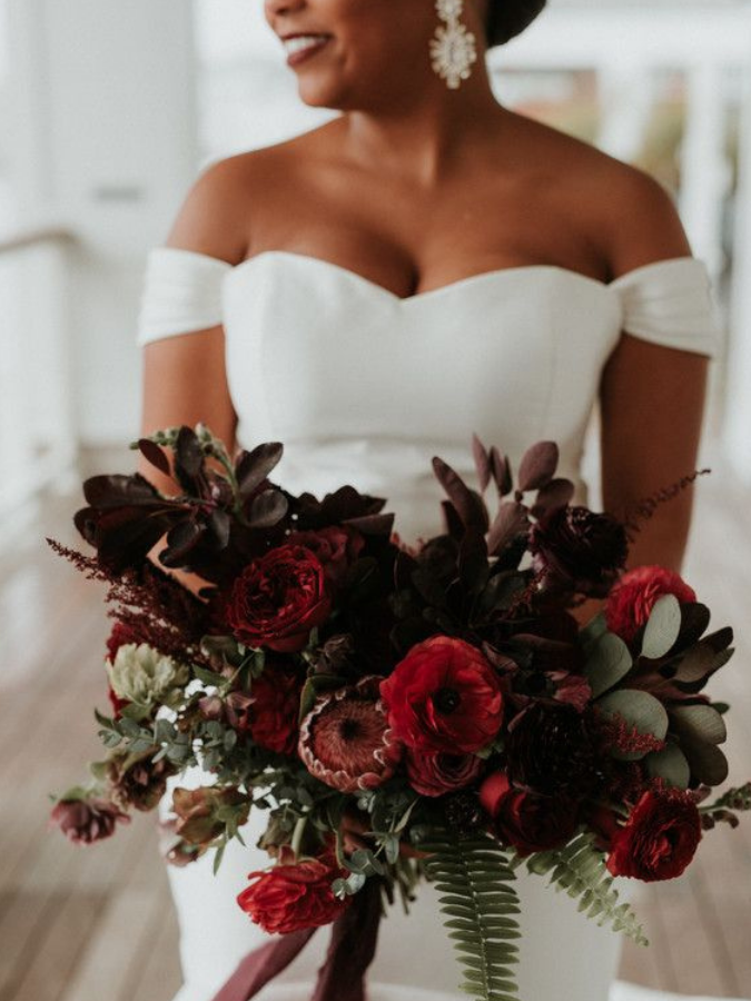 Bride holding dramatic burgundy bouquet