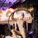 Acrobat in Gold Bodysuit at Carnival-Themed Wedding