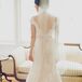 Katy wore an Allure Bridals dress that combined a vintage and romantic look. The entire gown covered in lace had a deep V-neck back with buttons going down the middle. Her fingertip-length veil added an elegant touch.