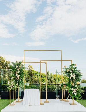 Ceremony Arch of Three Gold Structures on a White Stage With Greenery, Neutral Flowers