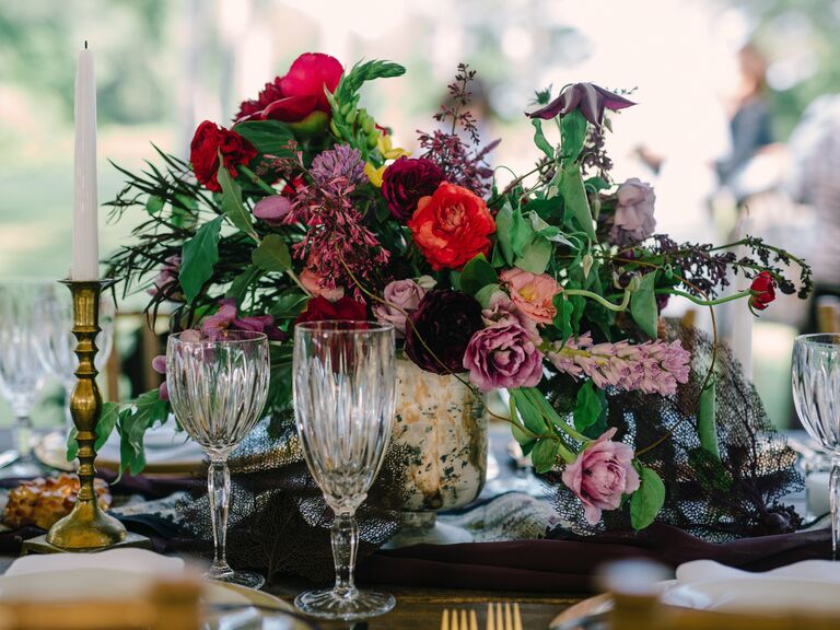 wedding centerpiece with burgundy, blush and yellow flowers