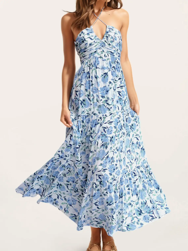 Model wearing a halter-neck dress with blue florals