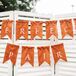 This sweetheart table accent was also a nod to their wedding favors. Along with placing Bosc pears on the dinnerware, Shelby and Zack highlighted their seating with this an orange “Perfect Pair” banner.