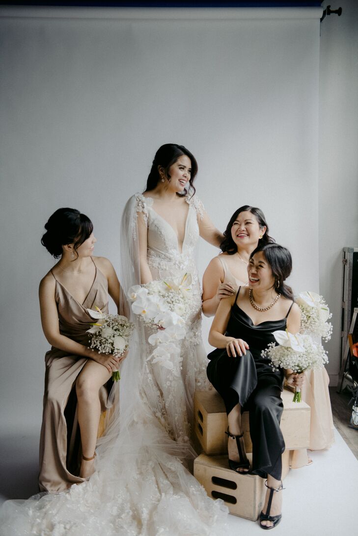 Bride in Glamorous Gown and Cape With Bridesmaids in Different Neutral Gowns, White Bouquets