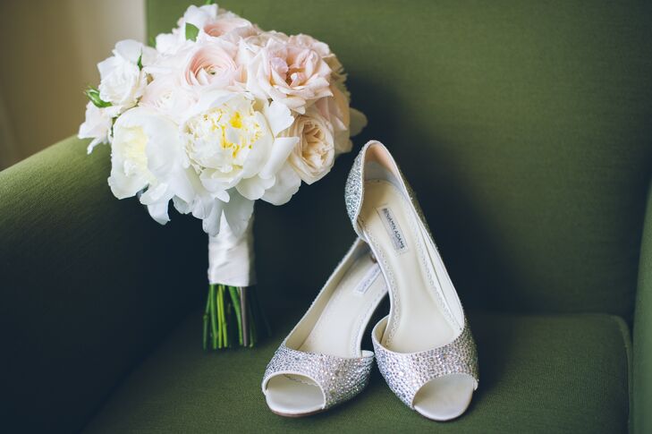 Pamela wanted to make sure her wedding day look included a “bling” factor. So, she sported a stand-out pair of Swarovski crystal-accented heels by Benjamin Adams. For her bouquet, however, she kept things subtle and romantic. Fleurescent filled its white satin wrap with white peonies, blush ranunculus as well as pink and ivory roses.
