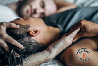 two men lying in bed