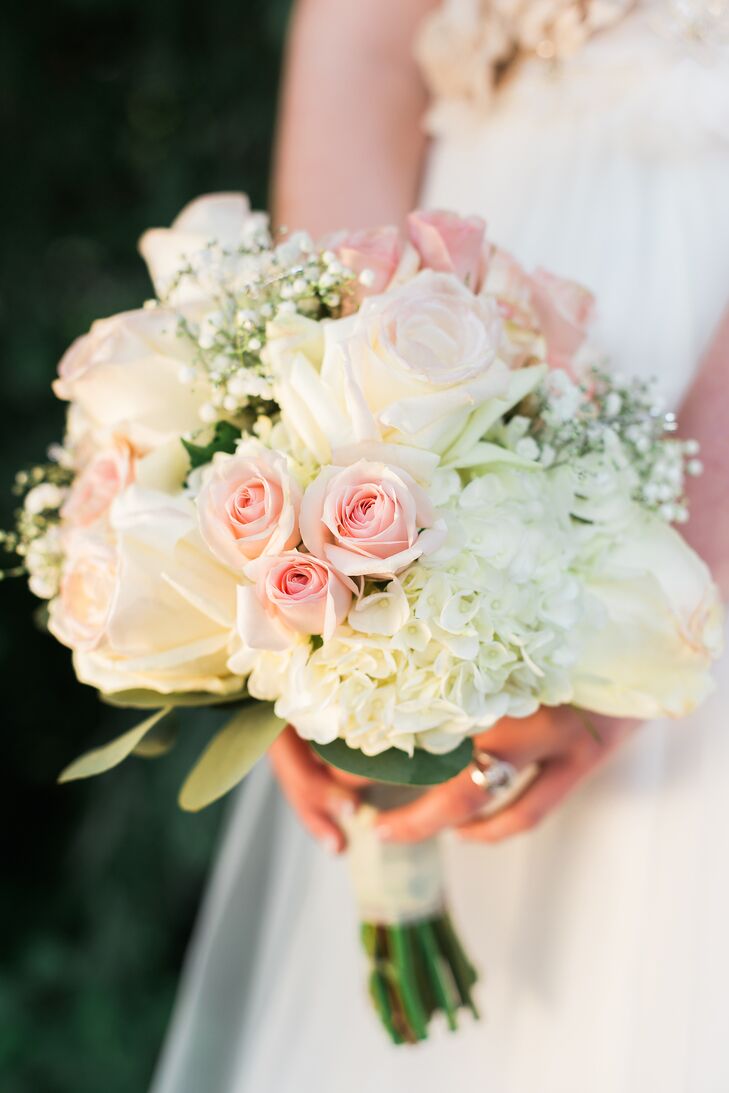 The bride's bouquet took inspiration from the rosettes in her sash and incorporated pink and white roses with hydrangeas and silver-dollar eucalyptus.