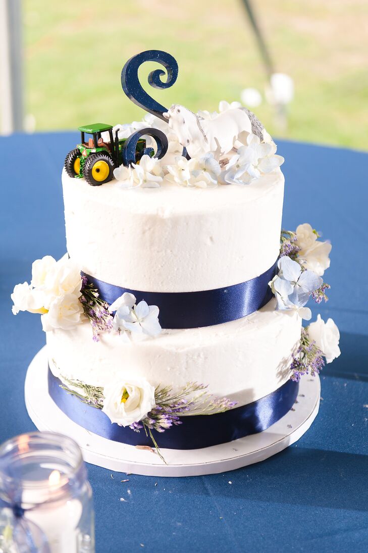 This wedding cake could't have been more personalized. Each buttercream-frosted layer was decorated with white lisianthus, white roses, blue hydrangeas and wisps of lavender. But what really caught out attention was the cake toppers. Rachael and Korey chose a white horse to represent her love of riding, a tractor to acknowledge his profession and a navy “S” as their toppers.