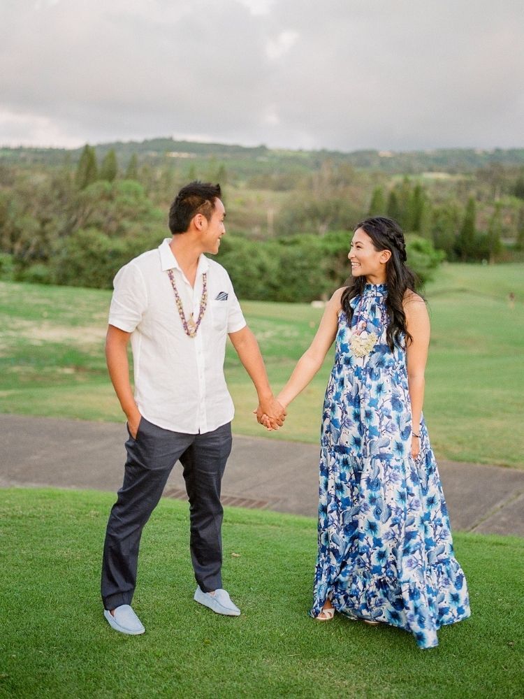 couple holding handing for engagement photo in Hawaii