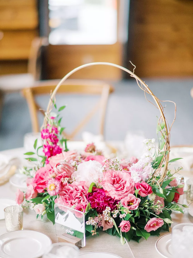 This beautiful hoop wedding centerpiece is completed by gorgeous flowers in different shades of pink.