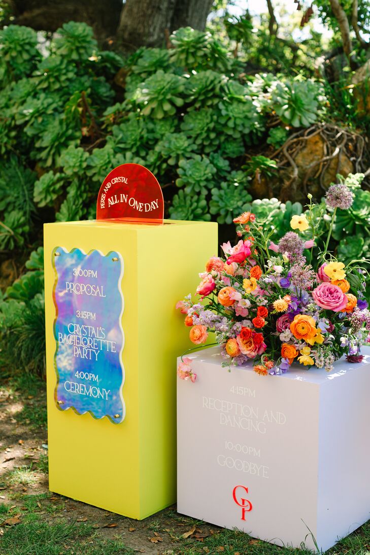 The couple’s planner explains that Persis and Crystal’s relationship inspired the “bright, exciting, bold and colorful” signage. The vibrant flower arrangements included alliums, ranunculus, roses and sweet peas.