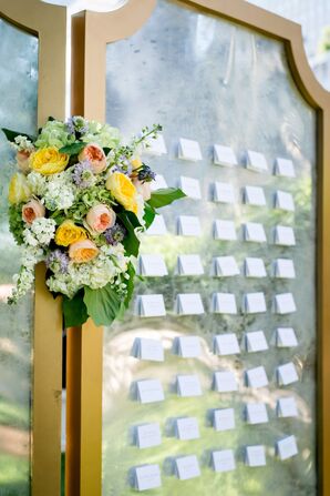 Flower Arrangement and Escort Card Wall At Wedding Reception