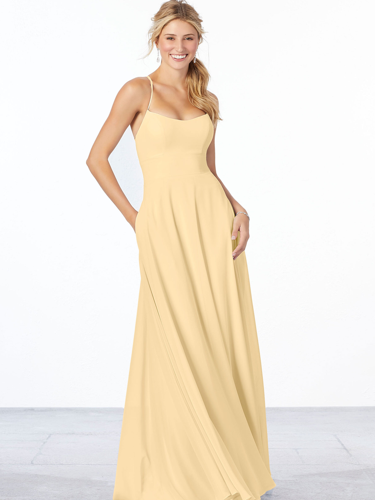 A model wears a spaghetti strap bridesmaid dress in a friendly canary yellow color.