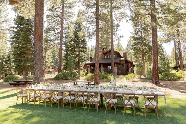 Reception Tables and Wood Cross-Back Chairs Under Towering Trees at Martis Camp in Truckee, California