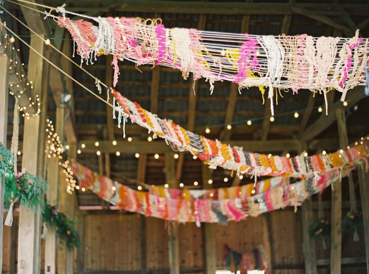 A large yarn display strung behind the sweetheart table added a homespun vibe to the couple's bold, bohemian-inspired decor. "We wanted our wedding to stand out from the norm and for our guests to feel an overwhelming sense of cheer and happiness," Courtney says.
