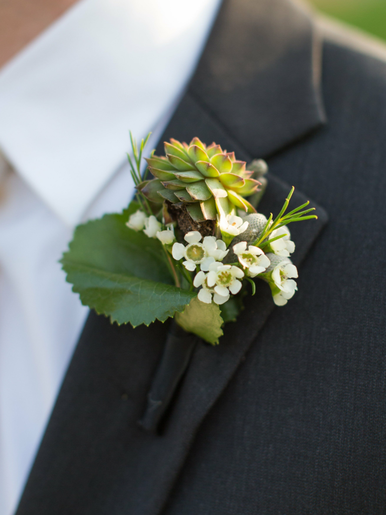 Boutonniere with wax flowers and succulents