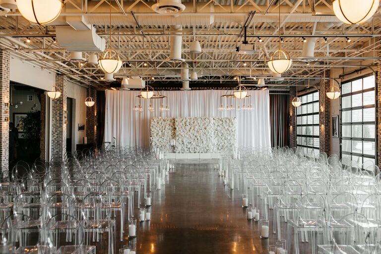 Wedding ceremony in loft with acrylic ghost chairs