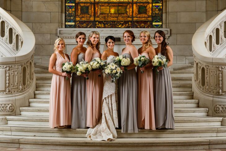 Lisa stood in the middle of her bridesmaids, who wore pink and gray long dresses designed by Jenny Yoo that were purchased from Nordstrom. They all held their bouquets of ivory roses and hydrangeas.