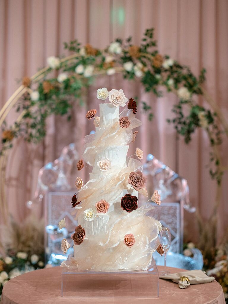 luxe wedding cake wrapped with swirls of sugar and flowers