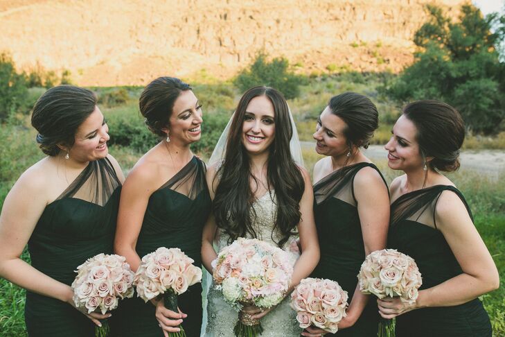 For the wedding party, Elle's bridesmaids wore designer black Amsale one-shoulder tulle mermaid-style gowns with simple black patent heels. Their blush and ivory bouquets were similar to Elle's.