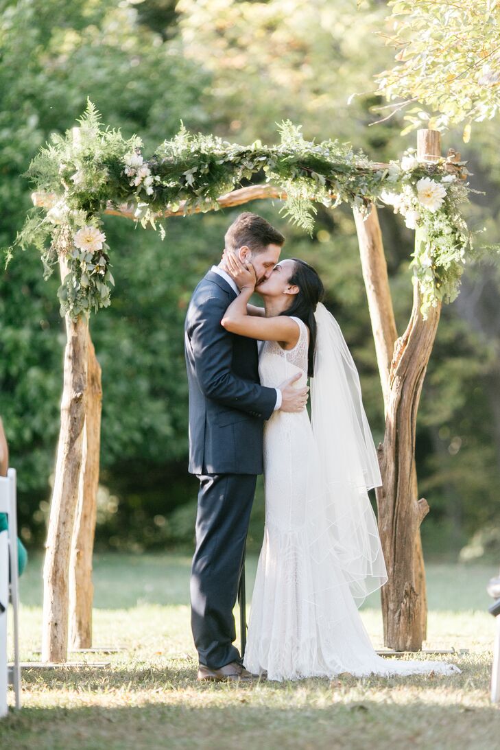 Newlyweds' First Kiss Under Birch Wedding Arch