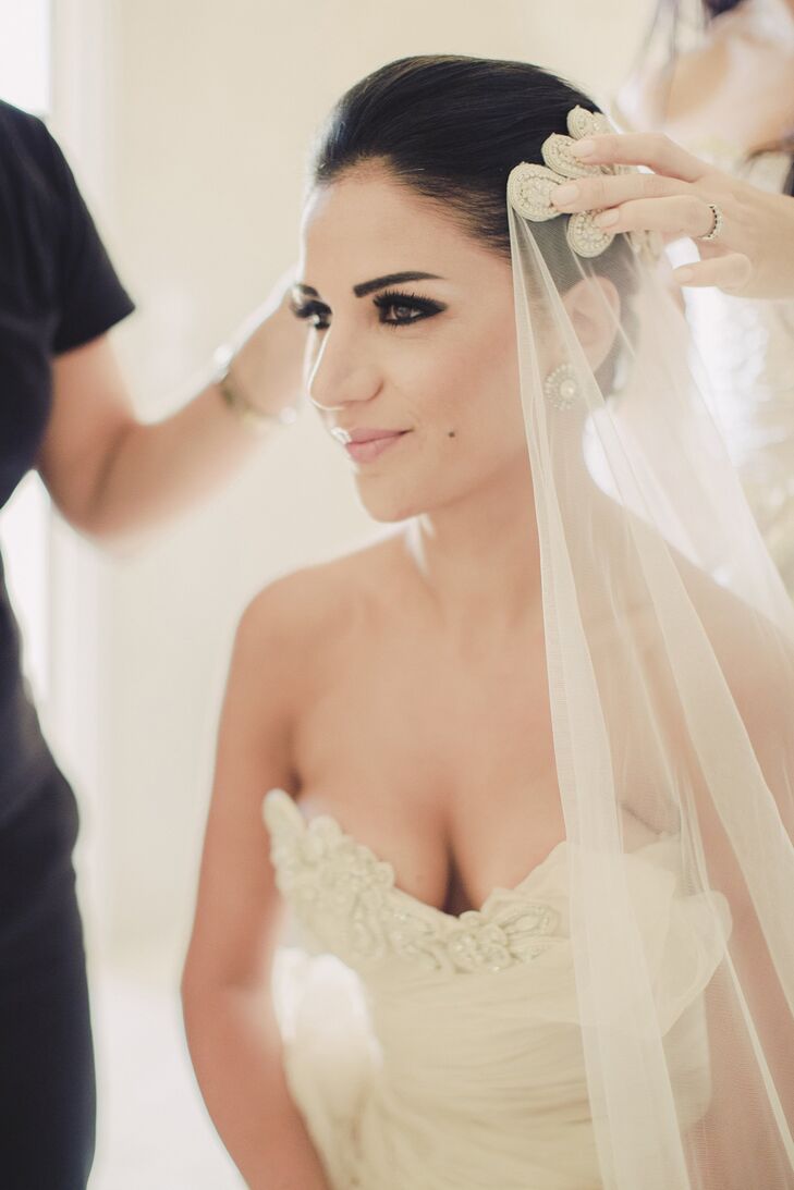 Miriam chose to go with a dark eye and nude lip for her destination wedding in Greece. Renia Bledaki in Greece did the bride's makeup, and Georgia Theodoraki did her updo.