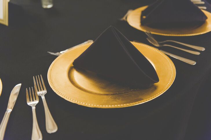 Gold chargers were paired with all-black linens for an elegant look that fit the aesthetic of the ballroom reception perfectly.