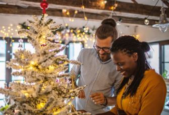 Couple decorating Christmas Tree