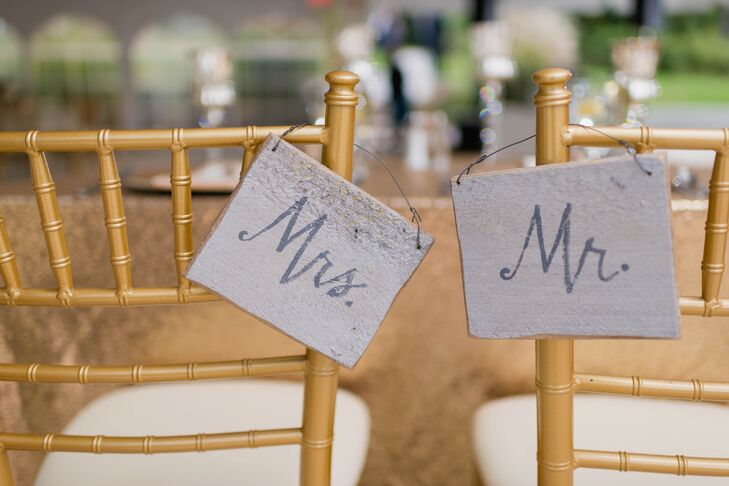 "Mr." and "Mrs." signs hung over the back of Katie's and Joe's gold chiavari chairs at the reception.
