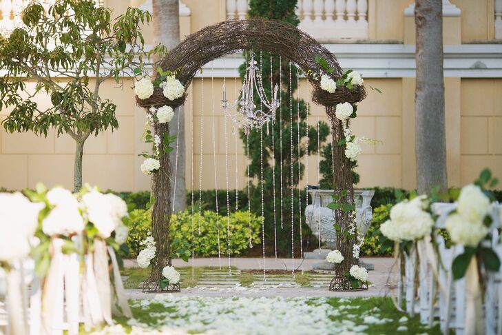 Amina and Brian were wed in The Ritz-Carlton, Sarasota garden under a vine-wrapped wedding arch accented with crystals,  white hydrangeas and a crystal chandelier.