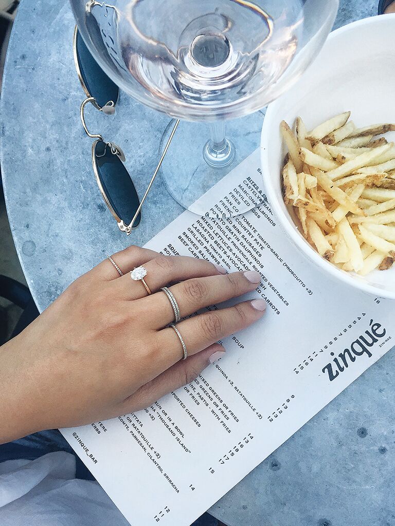 Casual engagement ring selfie idea with wine and french fries