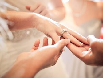 Wedding guests admiring bride's engagement ring