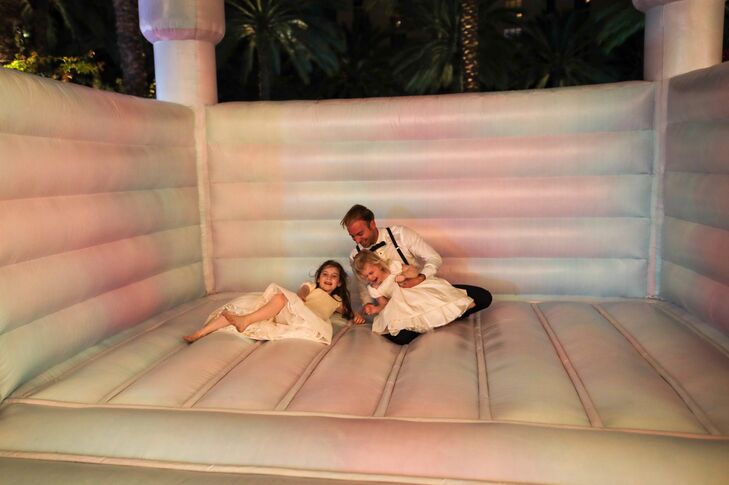 Groom in a Bounce House Playing With Flower Girls at Elegant Wedding Reception