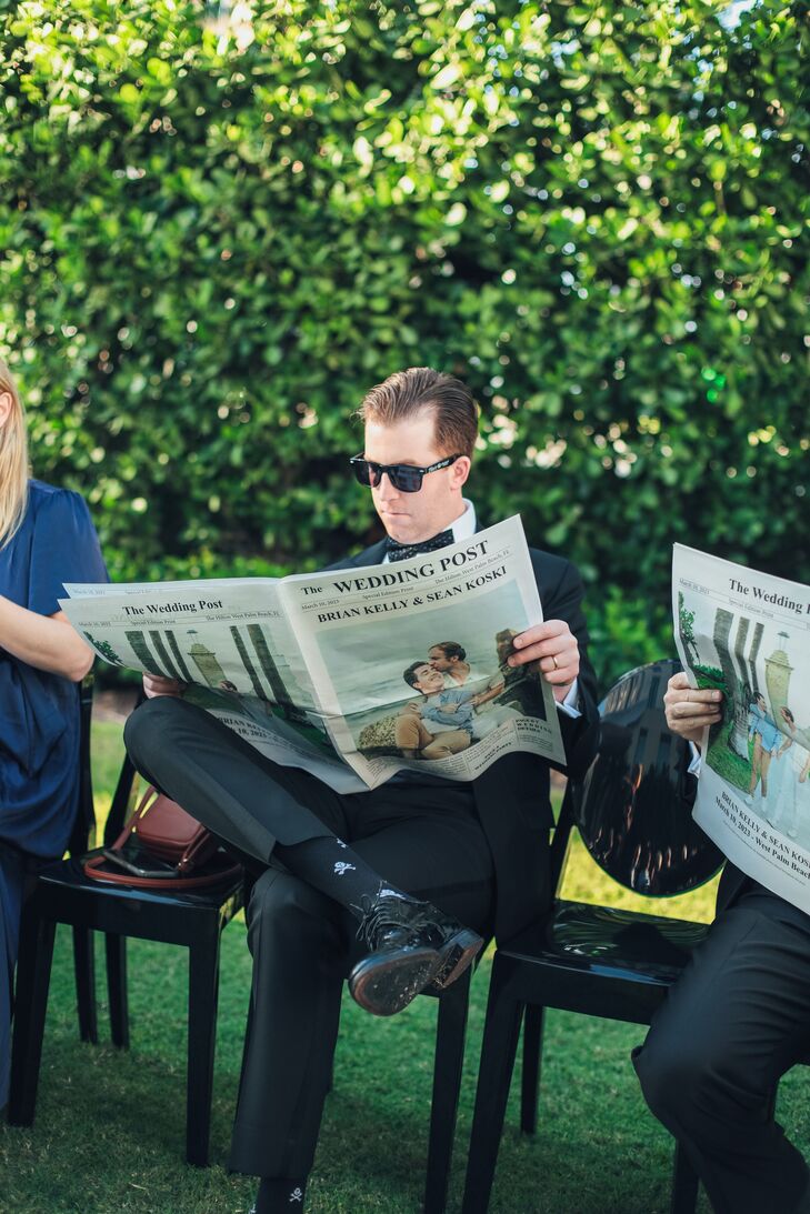Groom Reading Custom Newspaper With Couple's Wedding Information