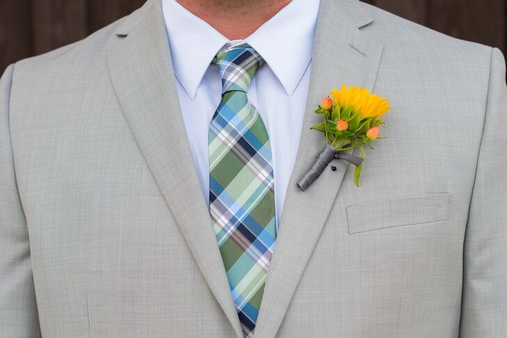 The groom wore a sunflower and hypericum berry boutonniere on his lapel.