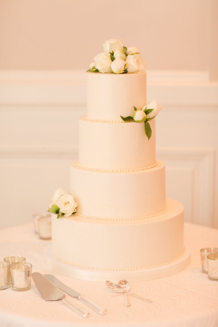 The crisp, white wedding cake, provided by Fluffy Thoughts Bakery, had a layer of coconut cake with vanilla cream cheese frosting and toasted coconut flakes. The other layers were chocolate with vanilla buttercream frosting and dark chocolate ganache.