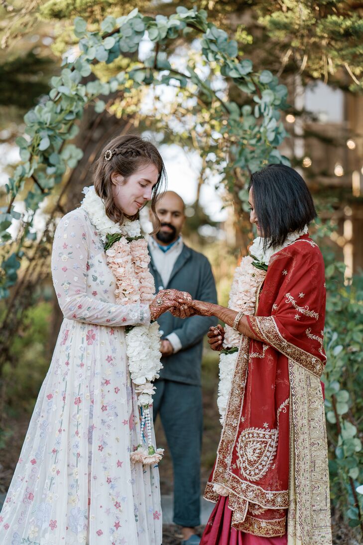 Couple Exchanging Wedding Rings While Wearing Marigold Garlands