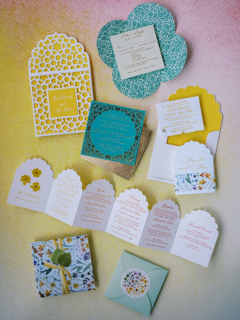 Colorful yellow and blue wedding invitation suite flat lay