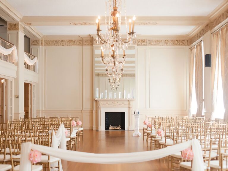 elegant ballroom wedding venue with fireplace decorated with floating candles in glass vases