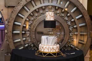 Modern Black-and-Gold Wedding Cake in Front of Historic Bank Vault