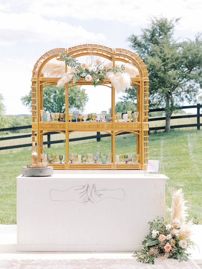 Boho bamboo bar at outdoor bohemian wedding reception